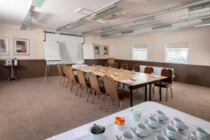 a conference room with a long table and chairs at Honest Lawyer Hotel in Durham