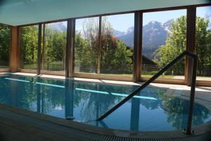 een zwembad met uitzicht op de bergen bij Appartement La Gentiane 63 in Chateau-d'Oex