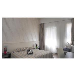 a hotel room with a bed and a window at Hotel Margherita in Monterosso al Mare