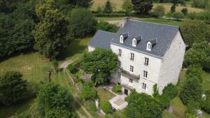 an aerial view of a large white house with a gray roof at Chez Jallot - Upper Gite in Vidaillat