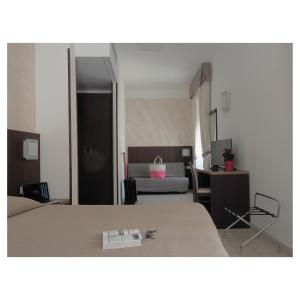 a bedroom with a bed and a room with a desk at Hotel Margherita in Monterosso al Mare