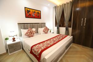 a bedroom with a large bed with a red blanket at Hotel Nature View Green Park Metro Couple Friendly New Delhi in New Delhi