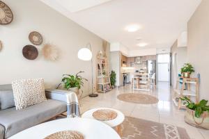 a living room with a couch and a table at Tyrwhitt Luxury Apartment in Rosebank in Johannesburg