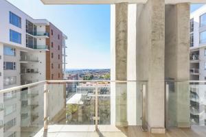 a view from the balcony of a building at Tyrwhitt Luxury Apartment in Rosebank in Johannesburg