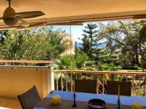 a dining room with a view of a balcony at Flat Sleeps 4 with Pool and Terrace in Mijas Costa