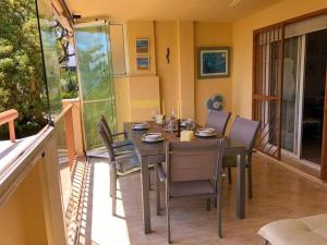 a dining room with a table and chairs at Flat Sleeps 4 with Pool and Terrace in Mijas Costa