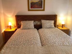 a bedroom with a bed with two lamps on both sides at Flat Sleeps 4 with Pool and Terrace in Mijas Costa +15 photos