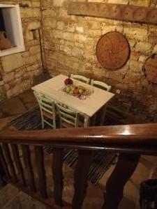 a table in a room with a white table and chairs at Kazani House Lofou in Lofou