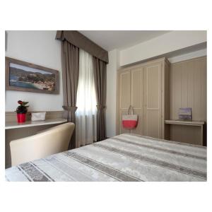 a bedroom with a large bed and a window at Hotel Margherita in Monterosso al Mare