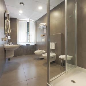 a bathroom with a shower and a toilet and a sink at Hotel Margherita in Monterosso al Mare +37 photos