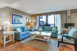 a living room with blue couches and a table at 1029 Captains Court in Fernandina Beach