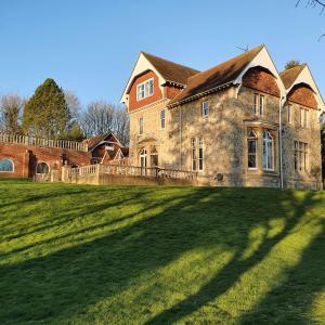 a large stone house with a large grass field at Country Manor House with indoor Pool and Hot Tub in Rochester