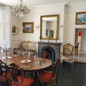 a dining room with a table and a fireplace at Country Manor House with indoor Pool and Hot Tub in Rochester