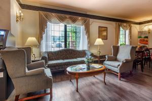a living room with a couch and chairs and a table at Quality Inn Montgomeryville-Philadelphia in Montgomeryville