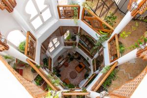 an overhead view of a building with wooden stairs and plants at Dar Liouba Hotel in Essaouira