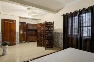 a room with wooden doors and windows and a room with at Meera Homes in Dehradun