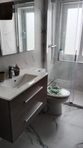 a bathroom with a sink and a toilet and a shower at Apartamento nuevo cerca de la costa y a 15 min de Bilbao! in Urduliz