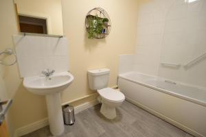 a white bathroom with a toilet and a sink at Park View in Hathern