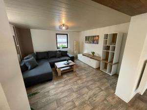 un soggiorno con un divano e un tavolo di Ferienwohnung Sonnenhof a Ammelsdorf
