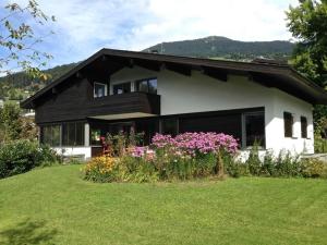 a house with some flowers in the yard at Chalet Montafon Schruns in Schruns-Tschagguns