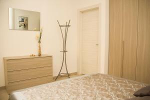 a bedroom with a bed and a dresser and a closet at InnPisaRentals - Loft in Pisa Historical Center in Pisa +11 photos