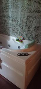 a bath tub with a toy sitting on top of it at Acogedora cabaña con piscina in Pontevedra +16 photos
