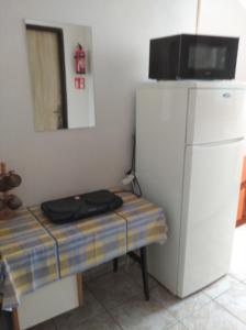 a room with a refrigerator and a table with a microwave at Pokoje Goscinne "Anna Maria" in Łeba