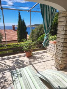 a patio with a view of the ocean at Apartments Pinezić in Martinšćica