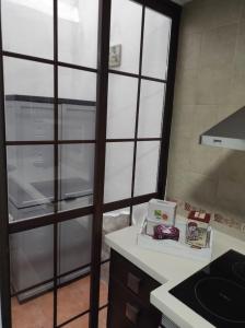 a kitchen with a refrigerator and a counter top at Al-Andalus Agradable casa para relajarse y descubrir Córdoba in Córdoba