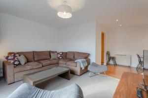 a living room with a couch and a table at A Spacious 2 Bedroom Apartment In Aldgate East in London