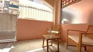 a room with a chair and a table and a window at Studio Bricka - 200m to the beach, parking, clim, terrace in Antibes