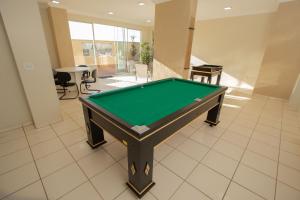 a pool table in the middle of a room at Hotel Toulon Caldas Novas in Caldas Novas