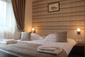 Vila Creasta Cocosului في بالتينيس: غرفة فندق عليها سرير وفوط
