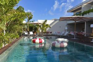a swimming pool with inflatables in a resort at Le Martin Boutique Hôtel in Saint Martin