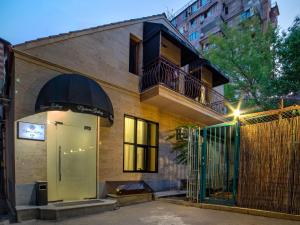 a building with a balcony and a door at Elysium Gallery Hotel in Yerevan