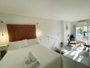 a bedroom with a white bed with towels on it at Eva Recommends San Gil in Seville