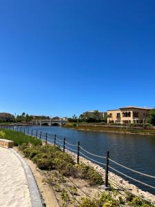 a path next to a river with a bridge at Elegant 1BR Chalet at Marassi Marina 2 in El Alamein