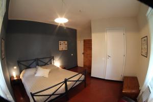 a bedroom with a bed and a white door at BBQ Lodge in Camogli