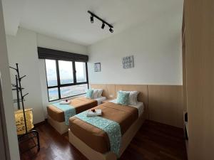 Postel nebo postele na pokoji v ubytování D'Gunduls Homestay Family Suite 2R 2B by DGH I-CITY