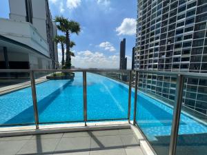 a view from the balcony of a building with a swimming pool at D'Gunduls Homestay Family Suite 2R 2B by DGH I-CITY in Shah Alam