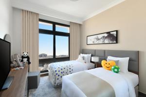 เตียงในห้องที่ Le Mirage Downtown