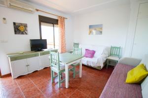 a living room with a table and a couch at Apartamentos Turisticos Trajano in Bolonia