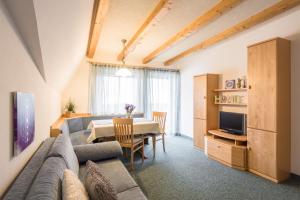 a living room with a couch and a table at Residence Pfeifhofer in Campo Tures