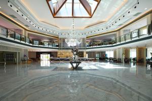 a large lobby with a chandelier in the middle at Crystal Paraiso Verde Resort & Spa - Ultimate All Inclusive in Belek