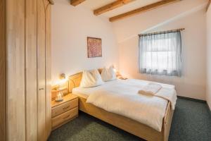 a bedroom with a large bed and a window at Residence Pfeifhofer in Campo Tures