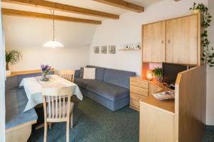 a kitchen and living room with a table and a couch at Residence Pfeifhofer in Campo Tures