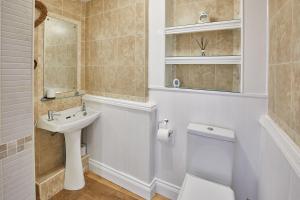 a white bathroom with a sink and a toilet at Host & Stay - The Duck Pond in Durham