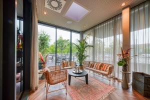 a living room with a couch and chairs and a table at NYCE Hotel Hannover in Hannover