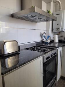 a kitchen with a stove and a counter top at BE Apartments Vicente in Mendoza