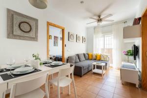 a kitchen and living room with a table and a couch at Apartamento centro Rota. 2 minutos de la playa.. in Rota